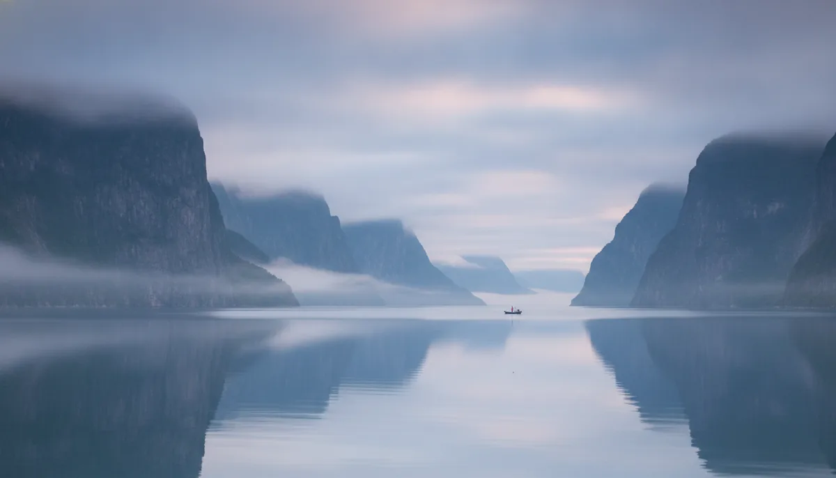 A first frame made from one sentence: a misty fjord at dawn
